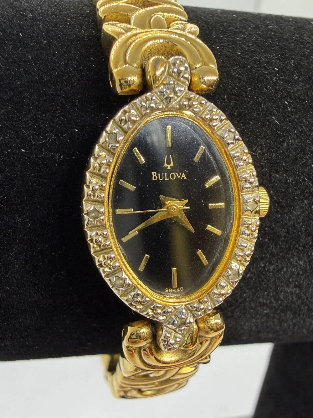 Bulova Gold Tone Dainty Oval Wristwatch Black Dial Textured Bezel Link Bracelet